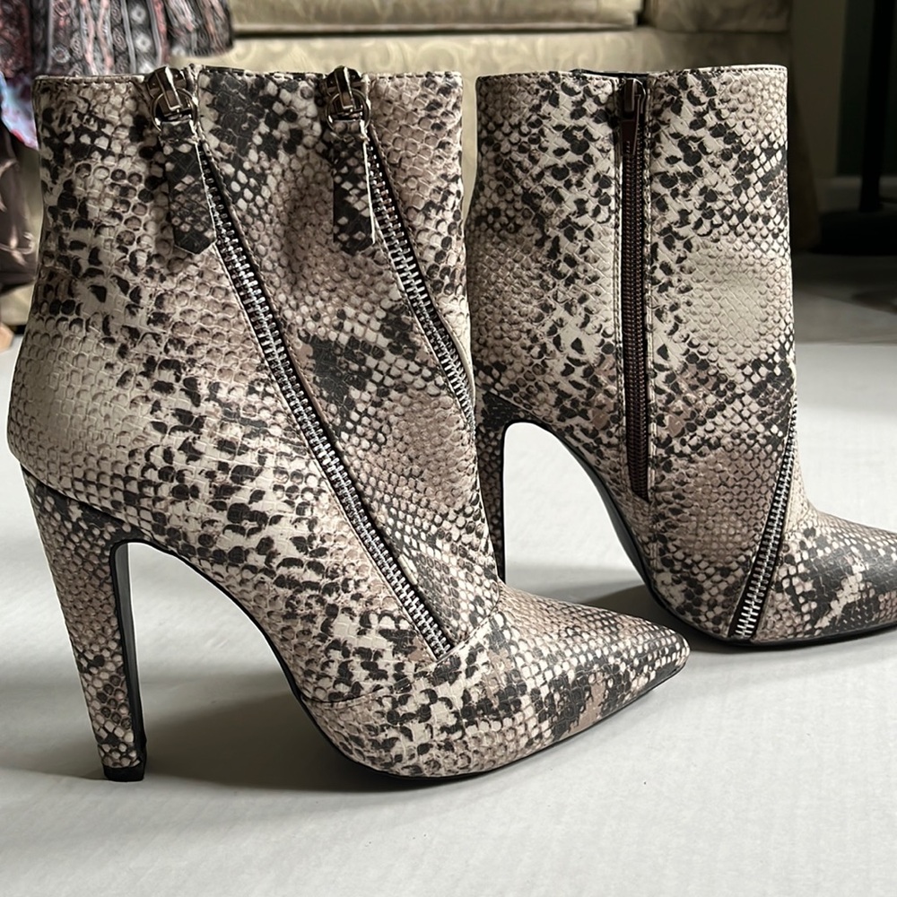 Snake print ankle booties with multiple zippers as design